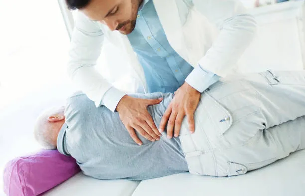 Quiropráctico haciendo ajustes vertebrales a paciente recostado como parte de un tratamiento de hernia discal personalizado